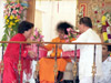 Bhagawan blessing devotees and accepting their traditional gifts given during the occasion