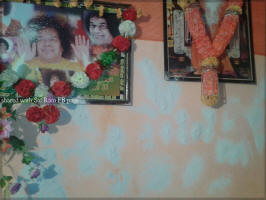 Vibhuti manifestation on wall & photographs at vill. Lunj, Himachal Pardesh